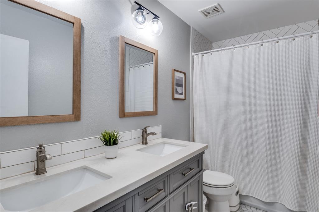 4018 Cedar Elm Lane Dallas, TX 75212 - Photo 17 of 22 a bathroom with a granite countertop sink and a mirror