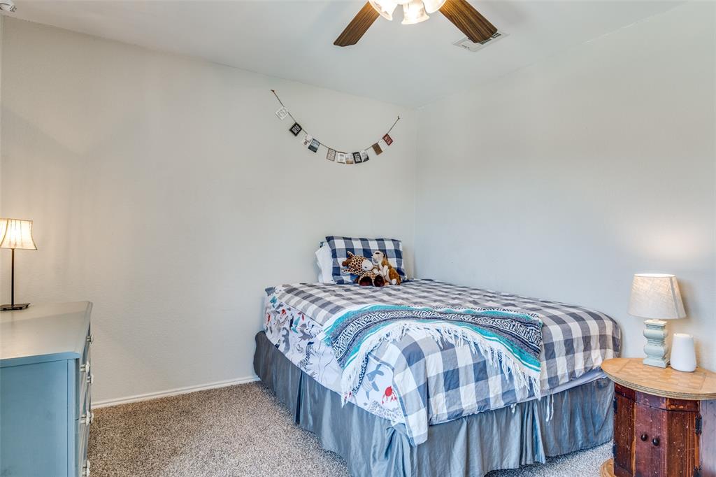 4018 Cedar Elm Lane Dallas, TX 75212 - Photo 18 of 22 a bedroom with a bed and wooden floor