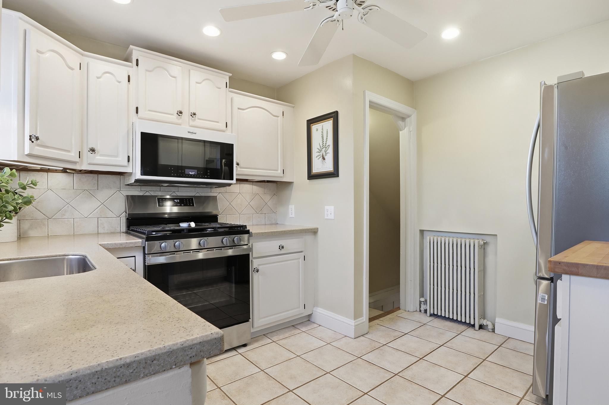 357 Old Garden Lane York, PA 17403 - Photo 14 of 62 a kitchen with stainless steel appliances granite countertop a refrigerator oven a sink dishwasher and white cabinets with wooden floor