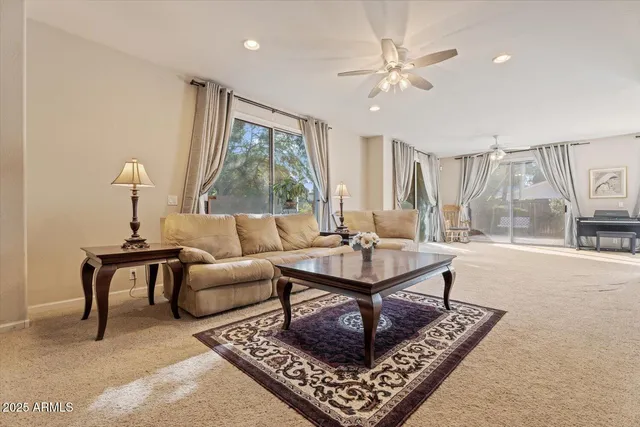 a living room with furniture a large window and a fireplace