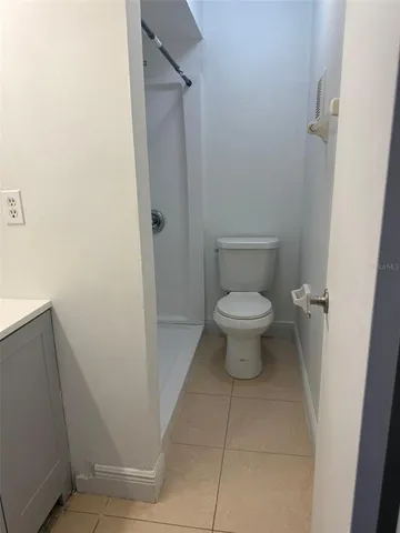 a white toilet sitting in a bathroom next to a sink