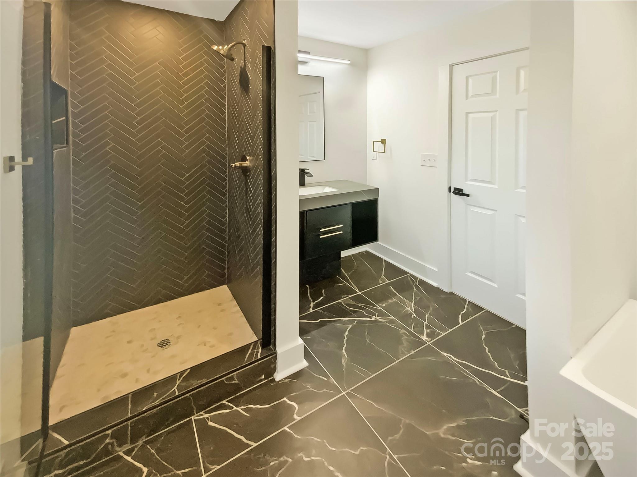 4914 Valley Stream Road Charlotte, NC 28209 - Photo 18 of 28 a bathroom with a sink and a shower