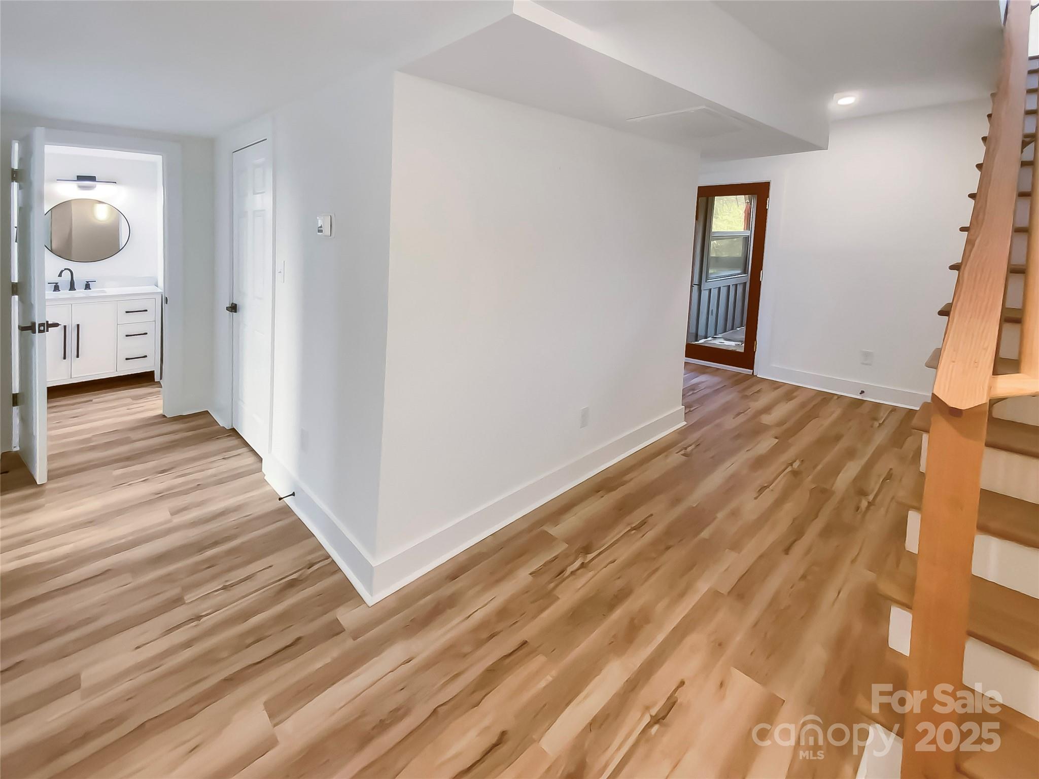 4914 Valley Stream Road Charlotte, NC 28209 - Photo 19 of 28 a view of a room with wooden floor and staircase