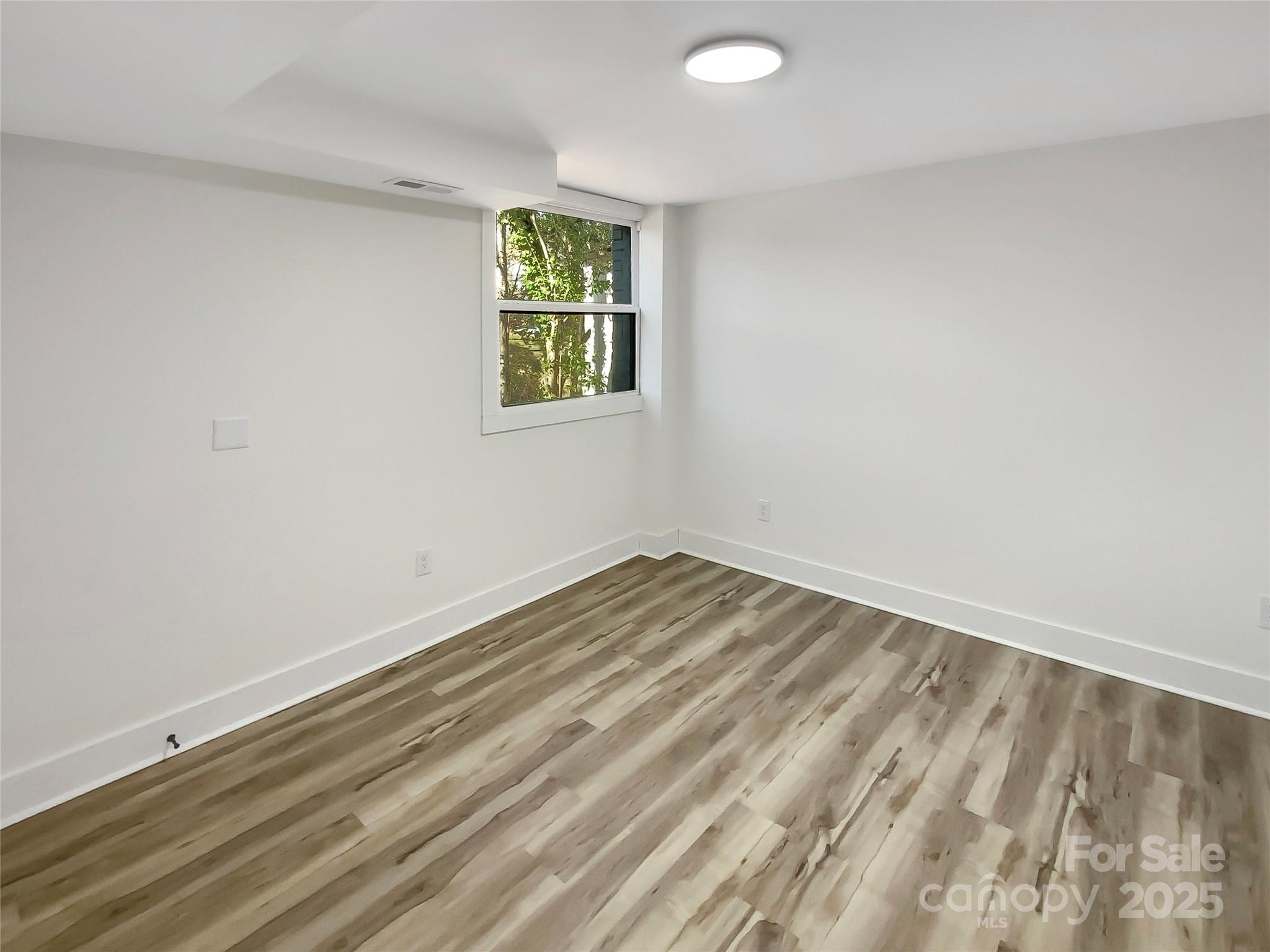 4914 Valley Stream Road Charlotte, NC 28209 - Photo 20 of 28 an empty room with a window