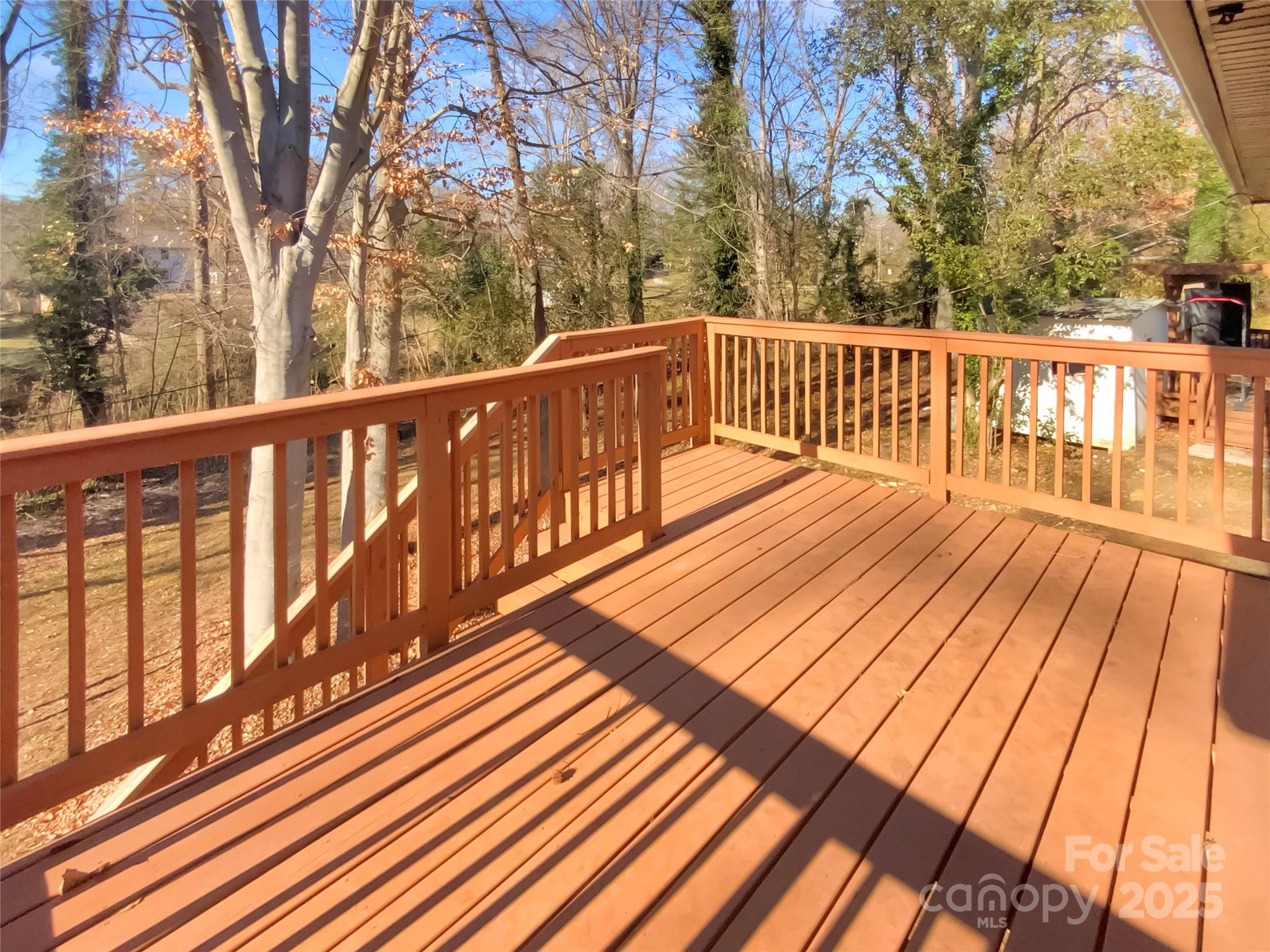 4914 Valley Stream Road Charlotte, NC 28209 - Photo 25 of 28 a view of balcony with wooden floor and fence