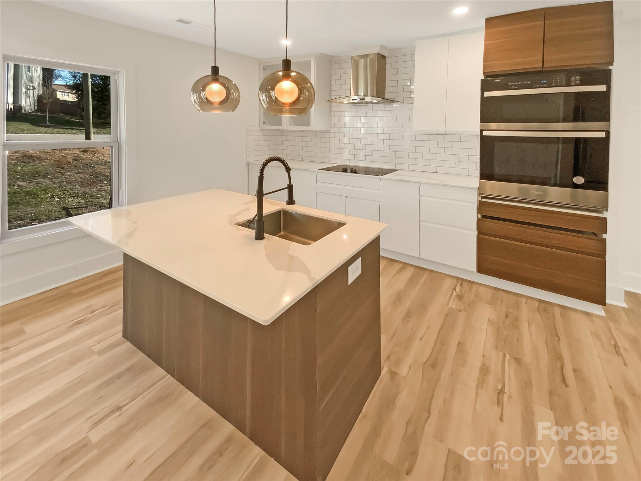 4914 Valley Stream Road Charlotte, NC 28209 - Photo 6 of 28 a kitchen with a sink and a refrigerator