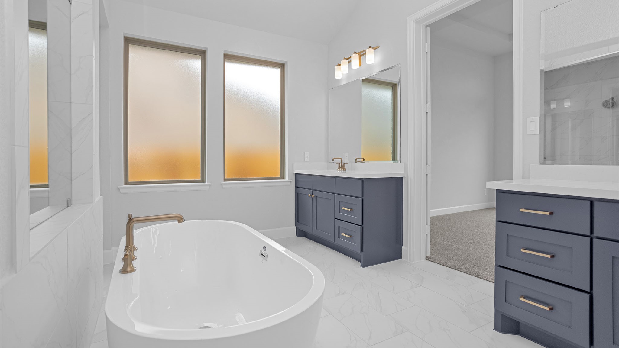 19011 Autumn Hazelnut Lane Manvel, TX 77578 - Photo 11 of 23 a bathroom with a bathtub and a sink