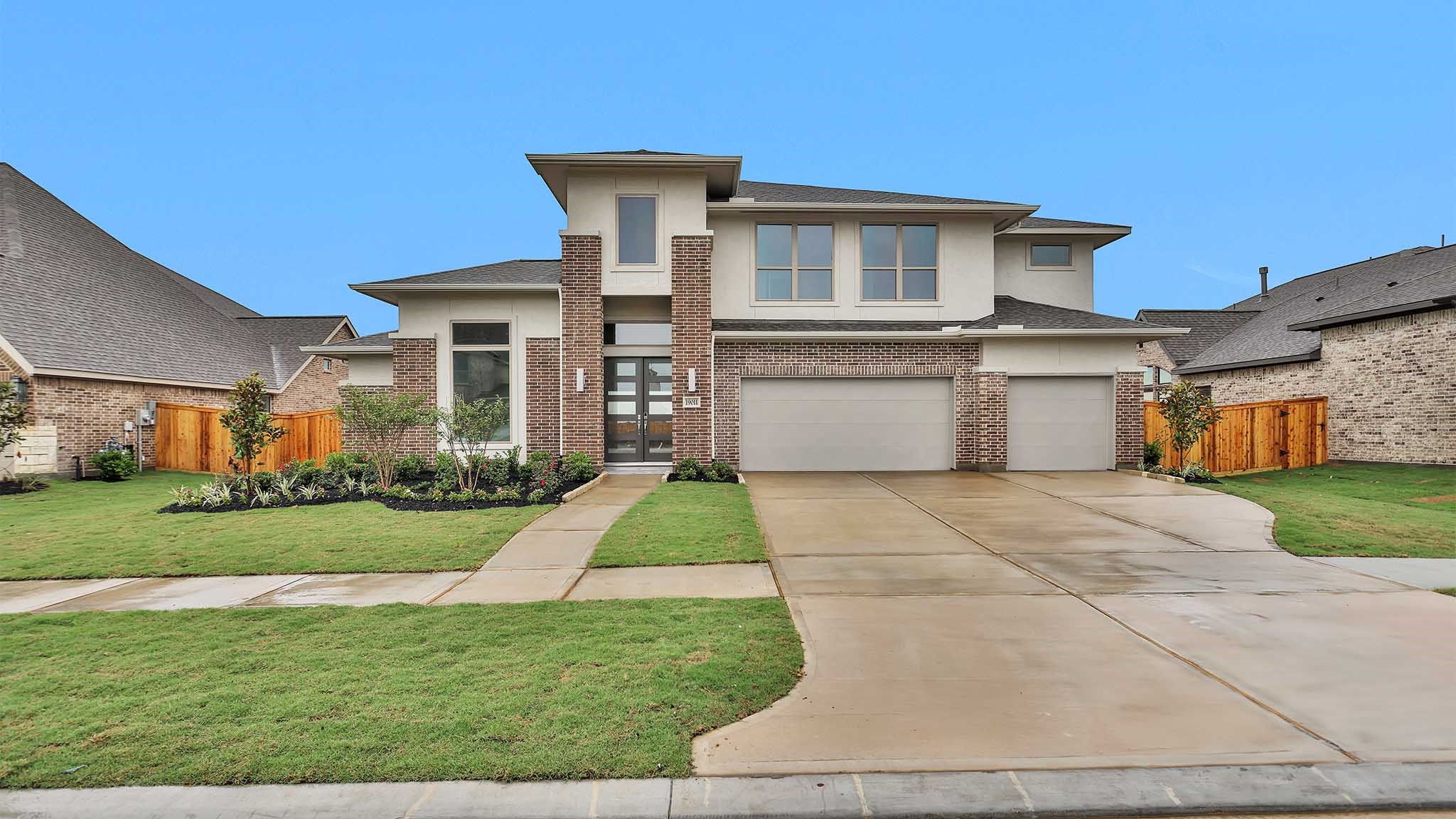 19011 Autumn Hazelnut Lane Manvel, TX 77578 - Photo 20 of 23 a front view of a house with a yard and garage