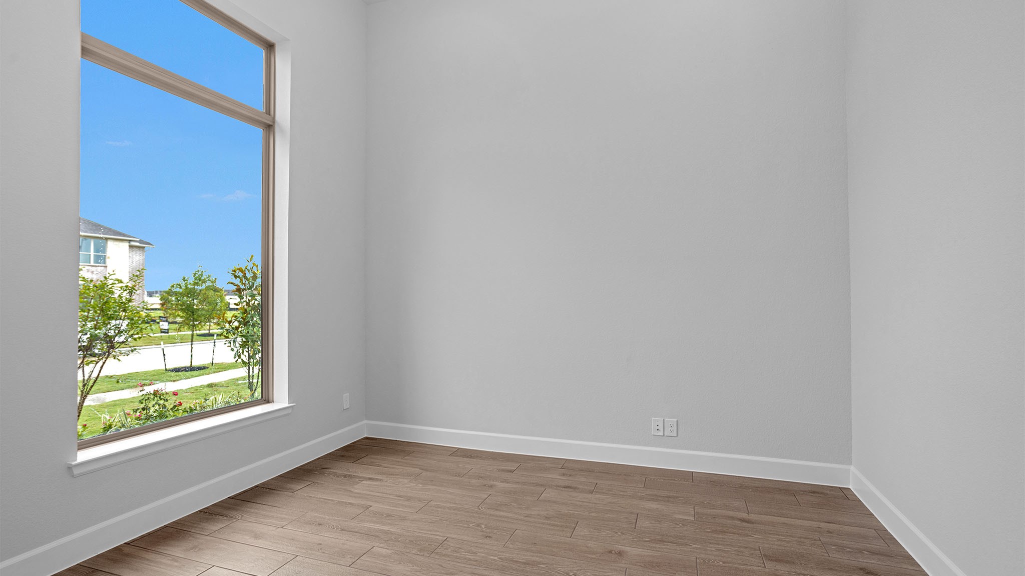 19011 Autumn Hazelnut Lane Manvel, TX 77578 - Photo 9 of 23 a view of an empty room with wooden floor and a window