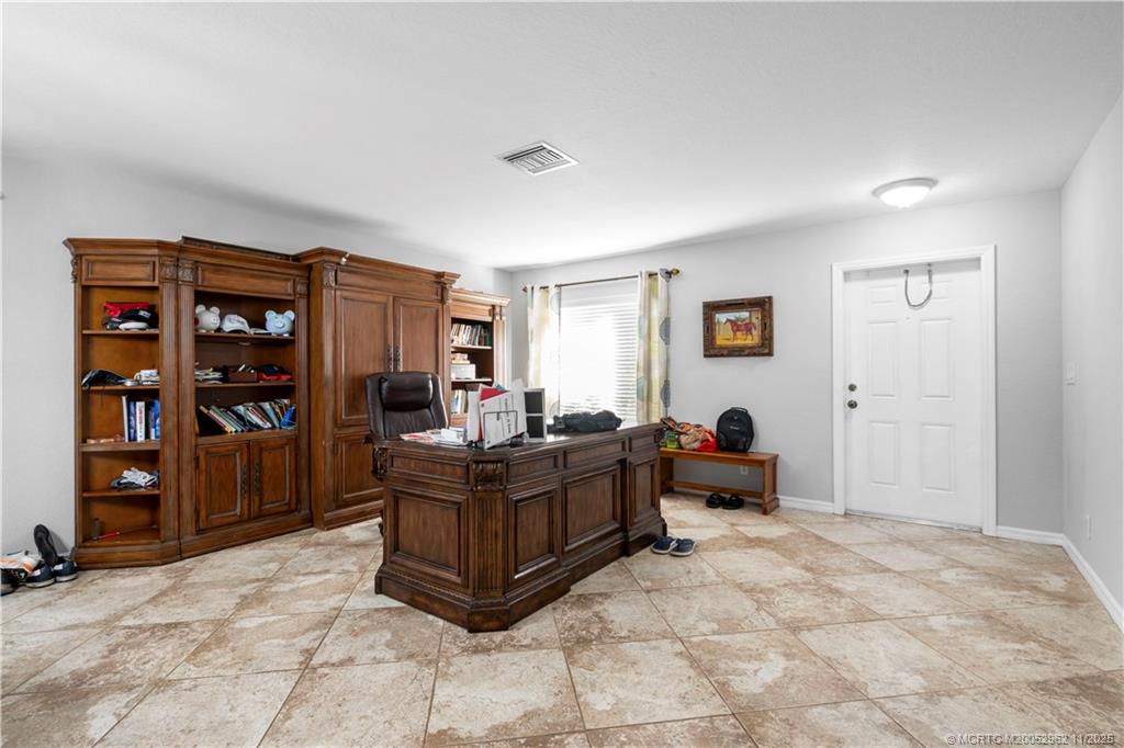 5532 Southeast Graham Drive Stuart, FL 34997 - Photo 11 of 43 a living room with furniture and a window