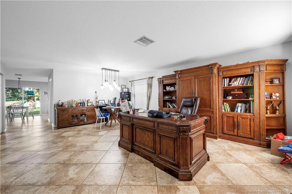 5532 Southeast Graham Drive Stuart, FL 34997 - Photo 12 of 43 a living room with furniture a air conditioner and a window