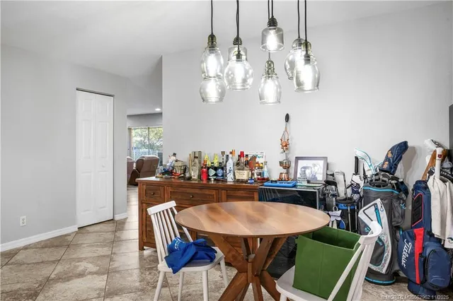 a view of a dining room with furniture and a chandelier