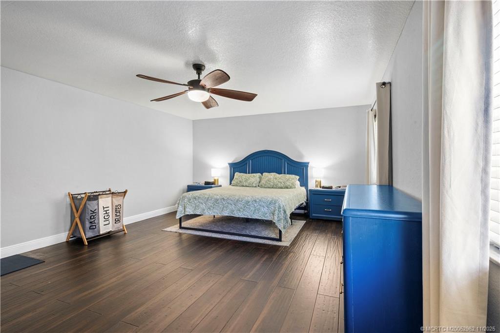 5532 Southeast Graham Drive Stuart, FL 34997 - Photo 15 of 43 a bedroom with a bed and a ceiling fan