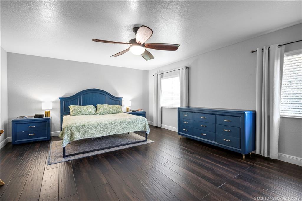 5532 Southeast Graham Drive Stuart, FL 34997 - Photo 16 of 43 a bedroom with a bed and a dresser