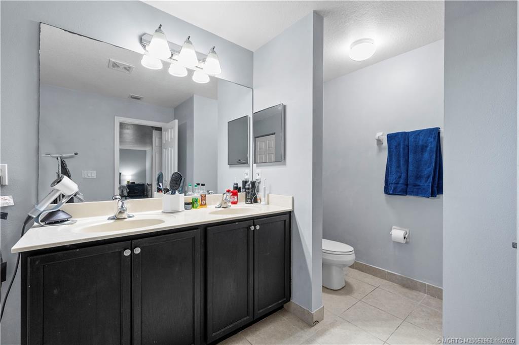 5532 Southeast Graham Drive Stuart, FL 34997 - Photo 20 of 43 a bathroom with a toilet sink and mirror