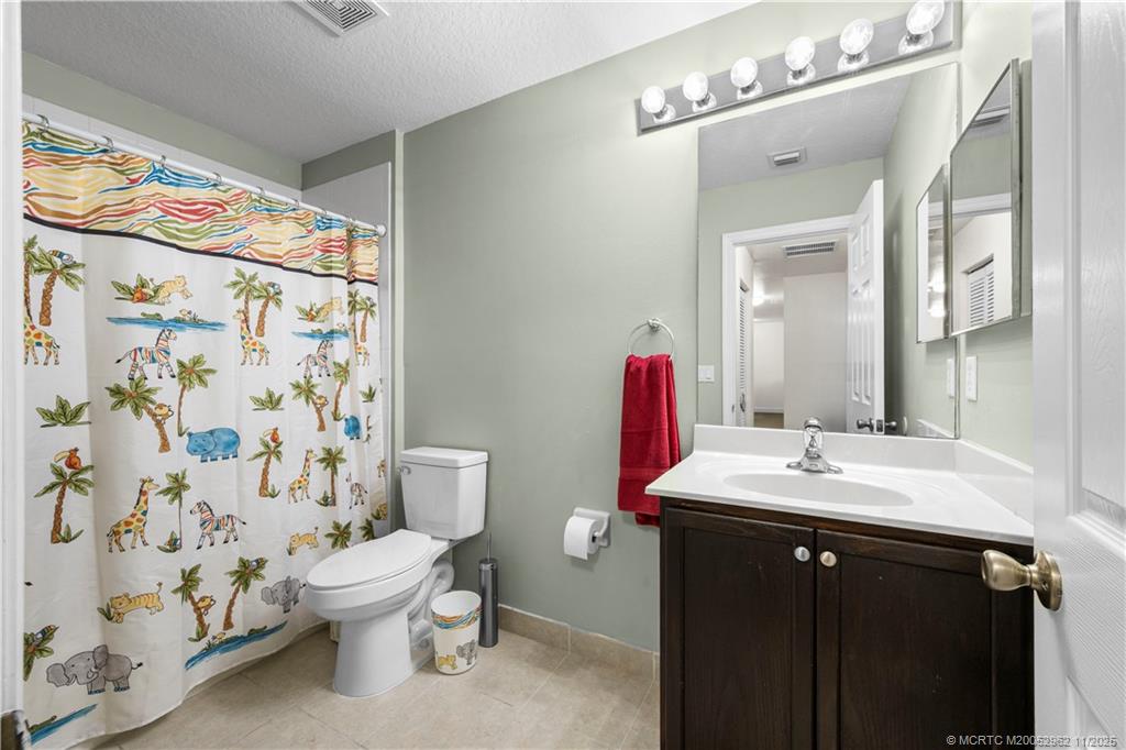 5532 Southeast Graham Drive Stuart, FL 34997 - Photo 21 of 43 a bathroom with a sink and mirror with toilet
