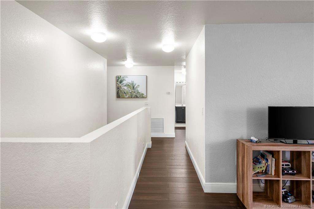 5532 Southeast Graham Drive Stuart, FL 34997 - Photo 22 of 43 a view of a livingroom with wooden floor and a flat screen tv