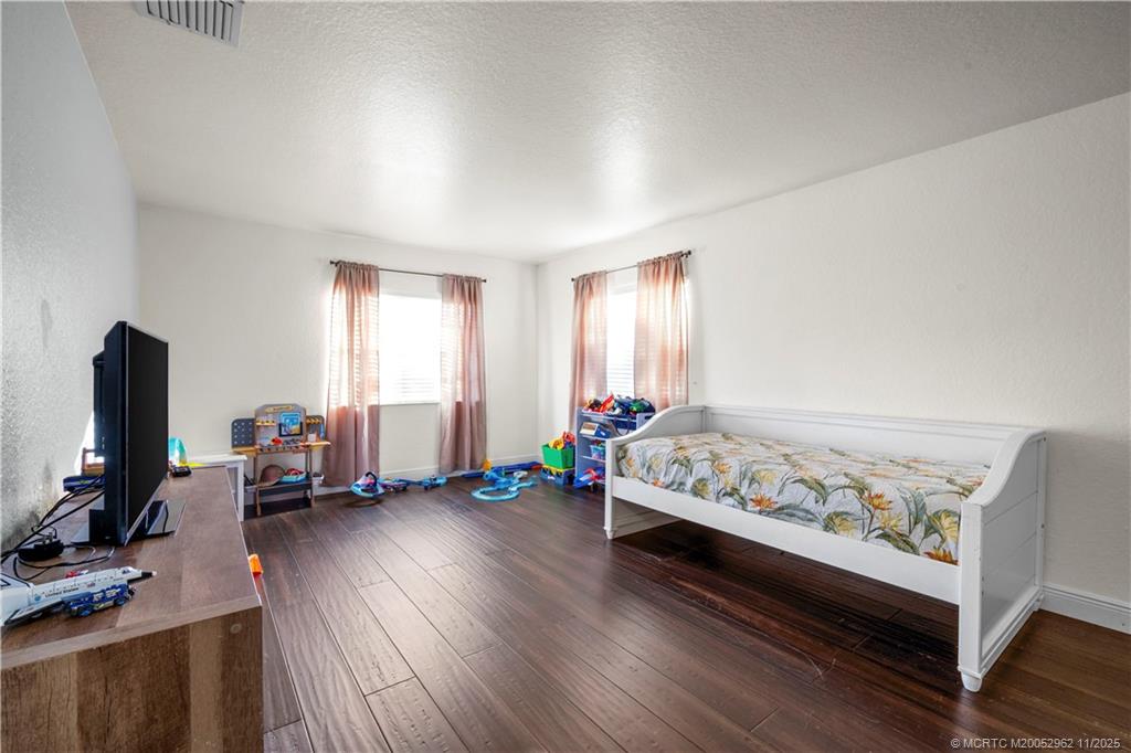 5532 Southeast Graham Drive Stuart, FL 34997 - Photo 24 of 43 a bedroom with furniture and a flat screen tv