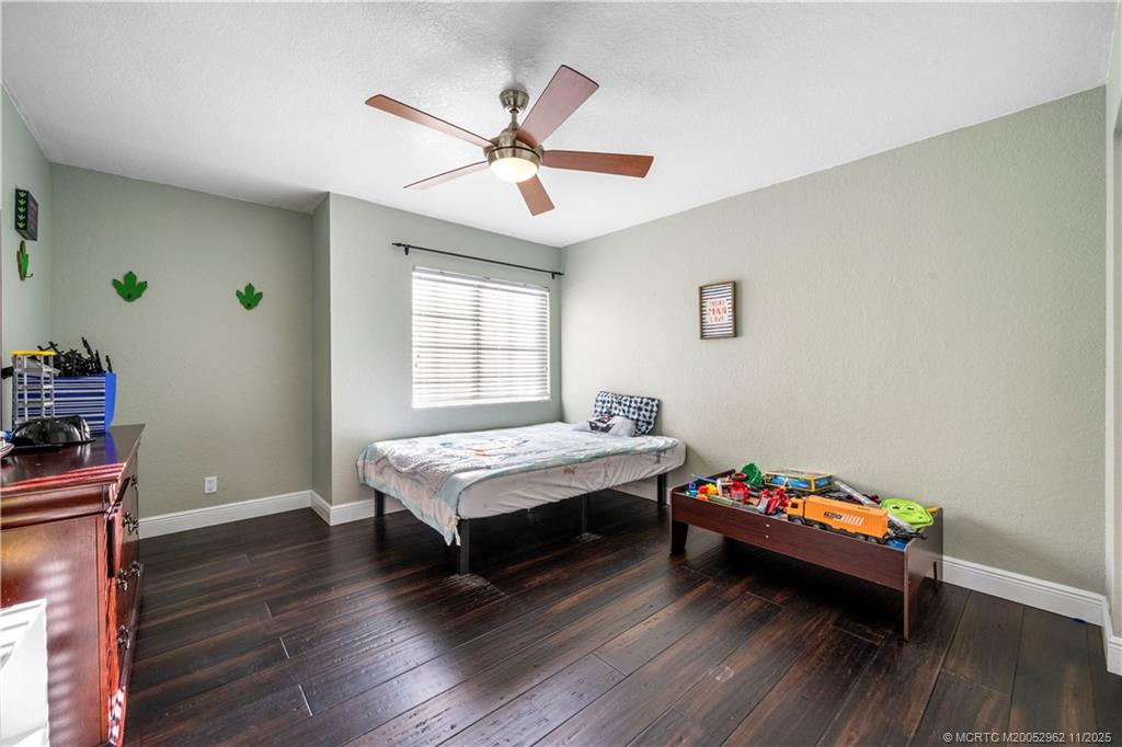 5532 Southeast Graham Drive Stuart, FL 34997 - Photo 25 of 43 a bedroom with bed and a window