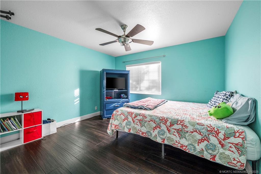 5532 Southeast Graham Drive Stuart, FL 34997 - Photo 27 of 43 a bedroom with a bed and a tv