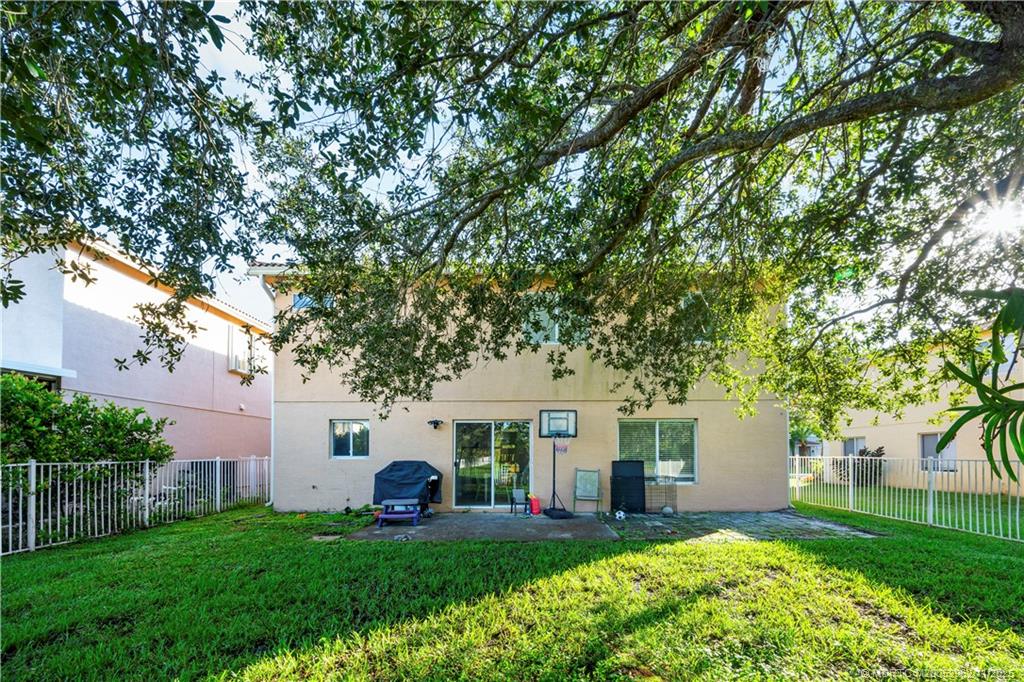 5532 Southeast Graham Drive Stuart, FL 34997 - Photo 30 of 43 a front view of a house with a yard and trees