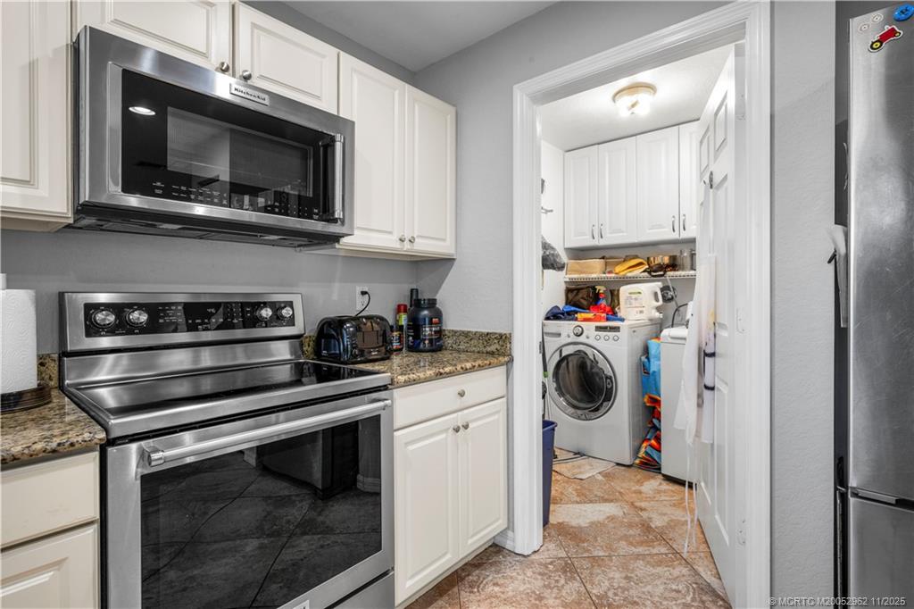 5532 Southeast Graham Drive Stuart, FL 34997 - Photo 3 of 43 a kitchen with a stove and a microwave