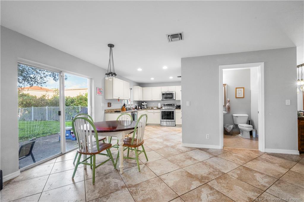 5532 Southeast Graham Drive Stuart, FL 34997 - Photo 6 of 43 a dining room with furniture and a floor to ceiling window