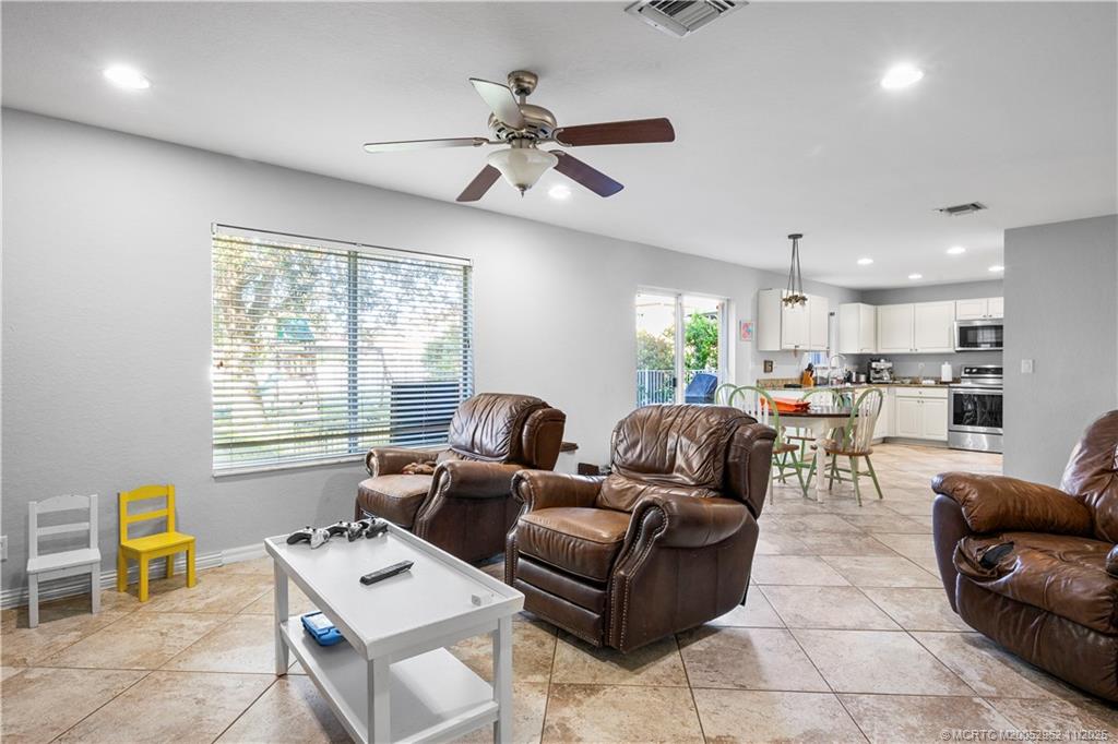 5532 Southeast Graham Drive Stuart, FL 34997 - Photo 9 of 43 a living room with furniture and a large window