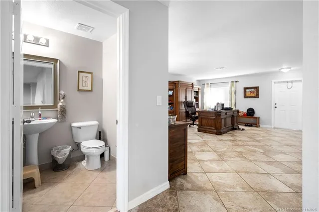 a view of a bathroom with a sink toilet and a living room
