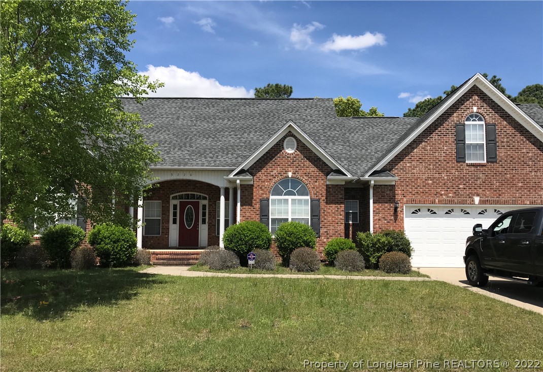 5220 Spreading Branch Road Hope Mills, NC 28348 - Photo 1 of 17 a front view of a house with a yard