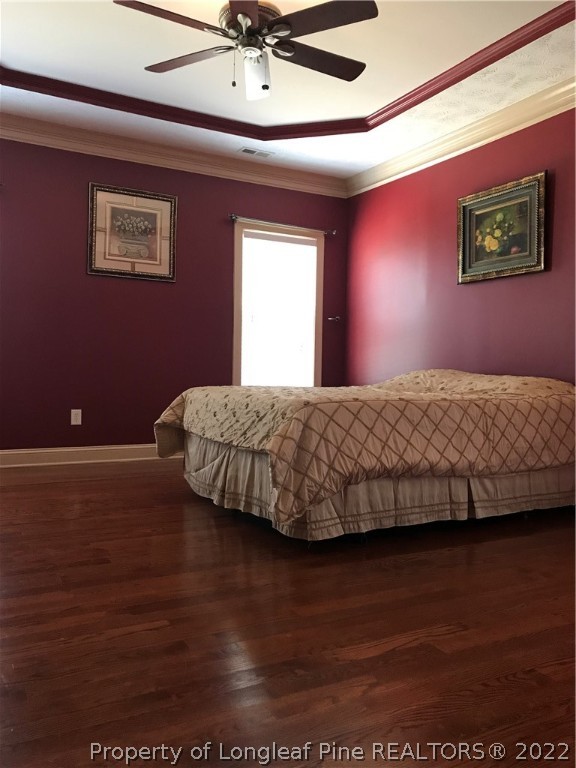5220 Spreading Branch Road Hope Mills, NC 28348 - Photo 11 of 17 a bedroom with a bed and wooden floor