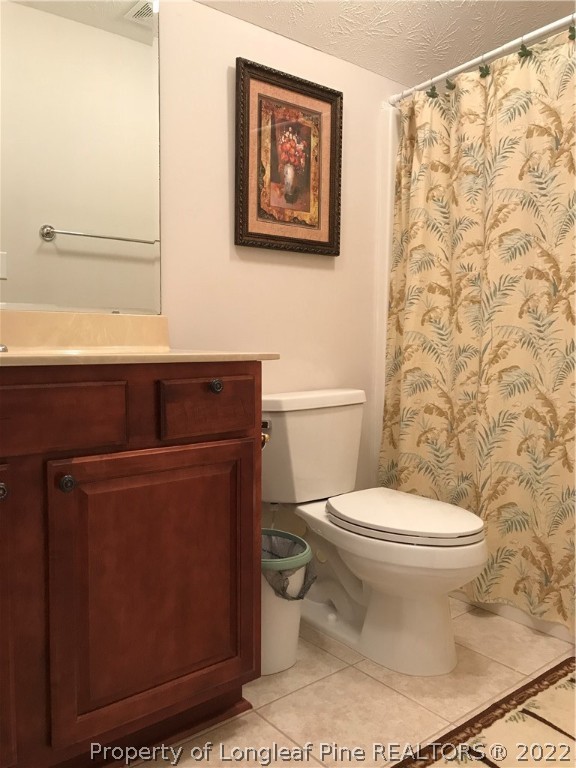 5220 Spreading Branch Road Hope Mills, NC 28348 - Photo 17 of 17 a bathroom with a toilet and a shower curtain