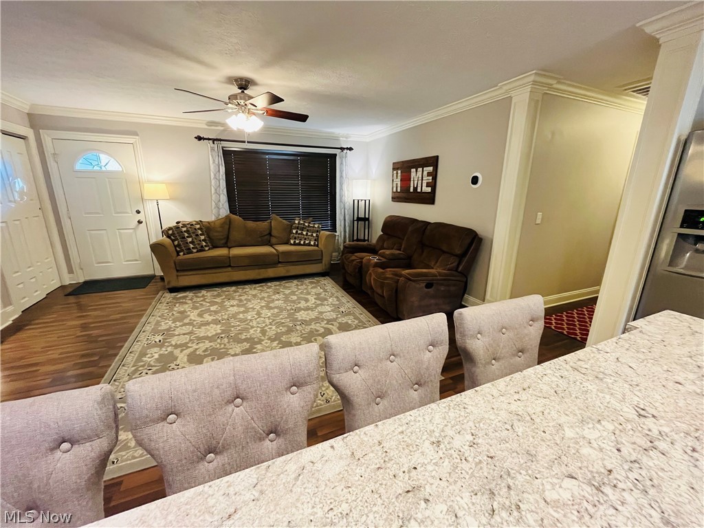6871 Byron Road Madison, OH 44057 - Photo 28 of 48 Living room featuring ornamental molding, dark wood-type flooring, and ceiling fan