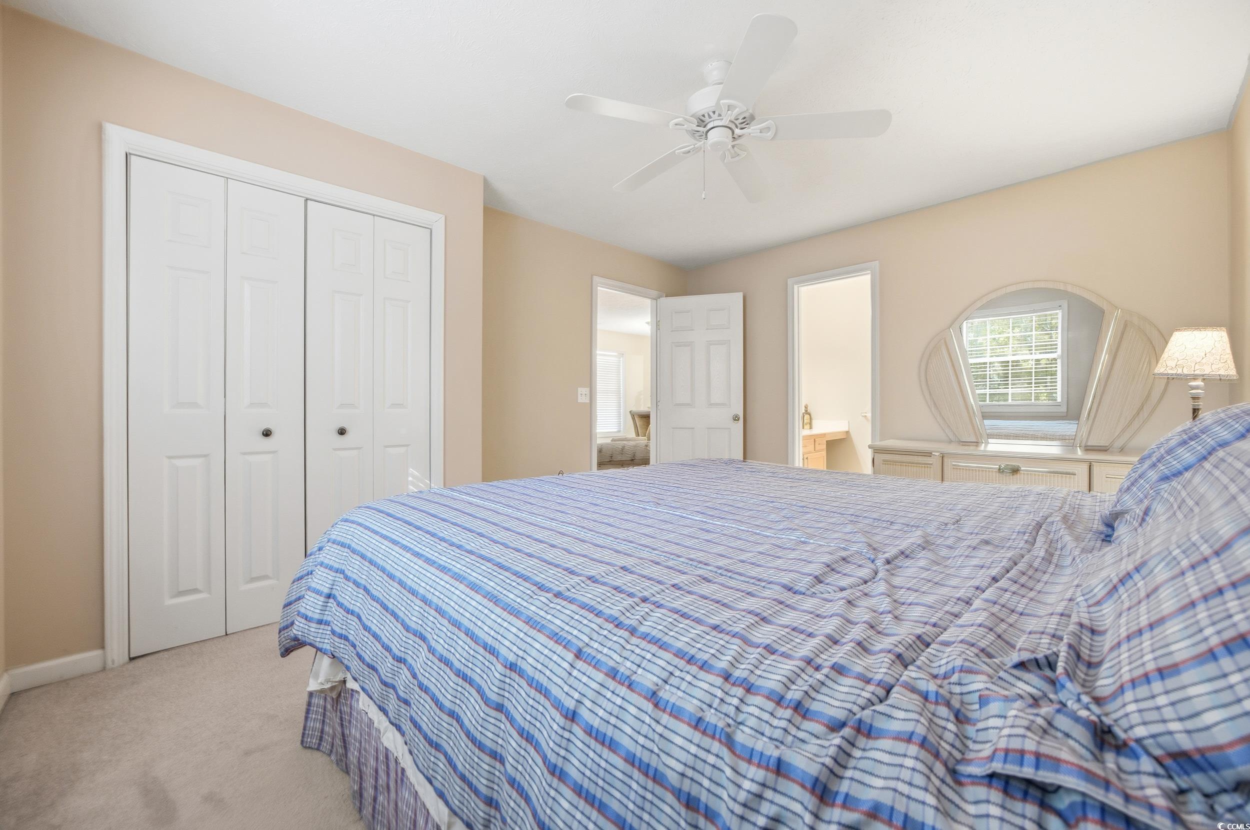 615 Tupelo Lane, Unit F Longs, SC 29568 - Photo 19 of 27 Carpeted bedroom with ceiling fan, a closet, and ensuite bath