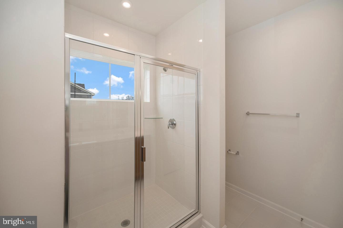 360 Coastal Avenue, Unit 102 Stafford, VA 22554 - Photo 19 of 25 a bathroom with a glass shower door
