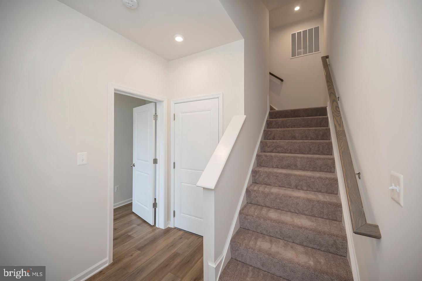 360 Coastal Avenue, Unit 102 Stafford, VA 22554 - Photo 2 of 25 a view of entryway with wooden floor and stairs
