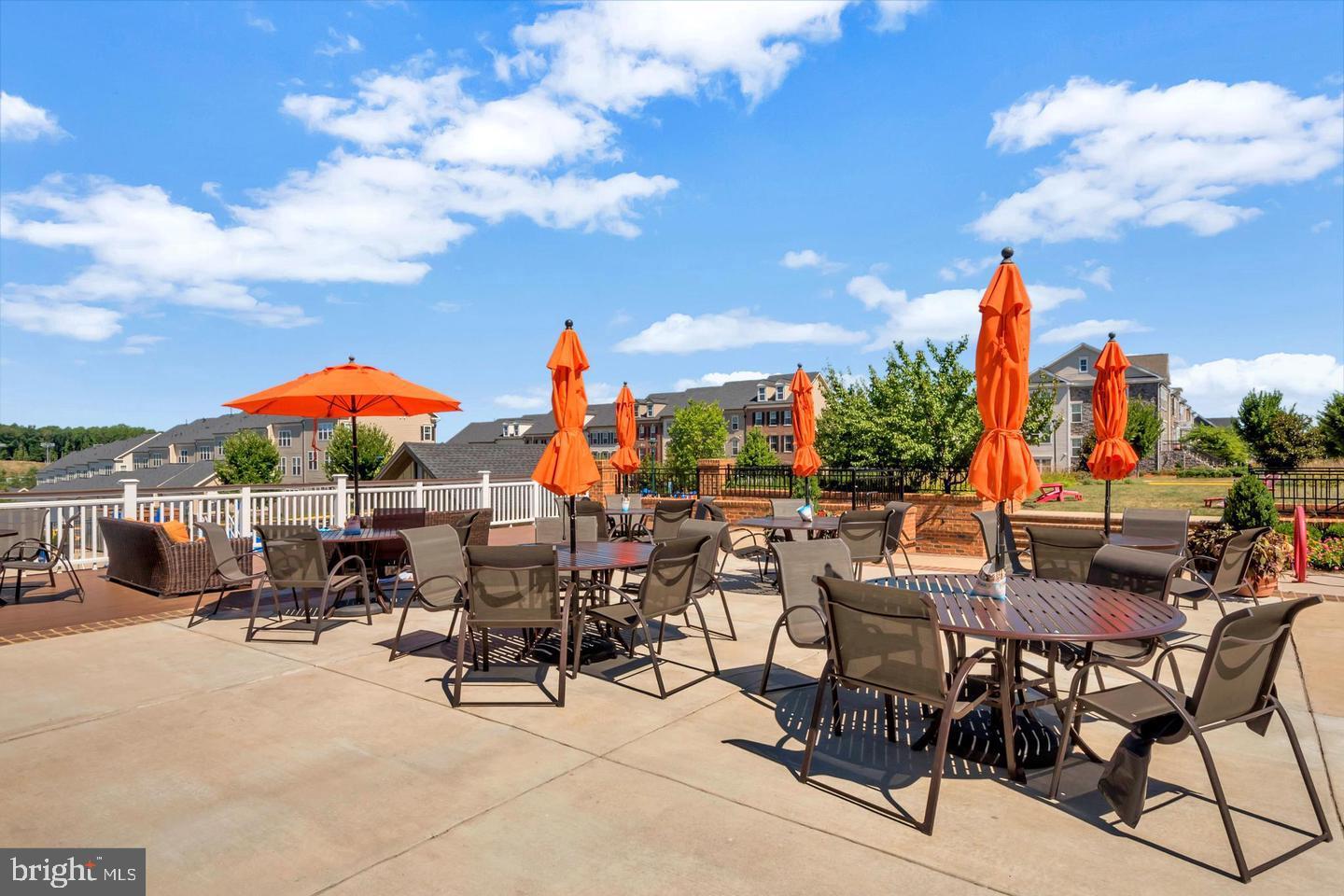 360 Coastal Avenue, Unit 102 Stafford, VA 22554 - Photo 22 of 25 an outdoor space with patio lots of furniture and umbrella