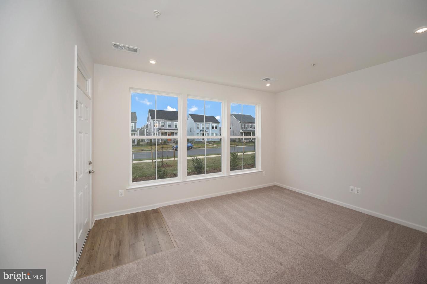 360 Coastal Avenue, Unit 102 Stafford, VA 22554 - Photo 3 of 25 an empty room with wooden floor and windows