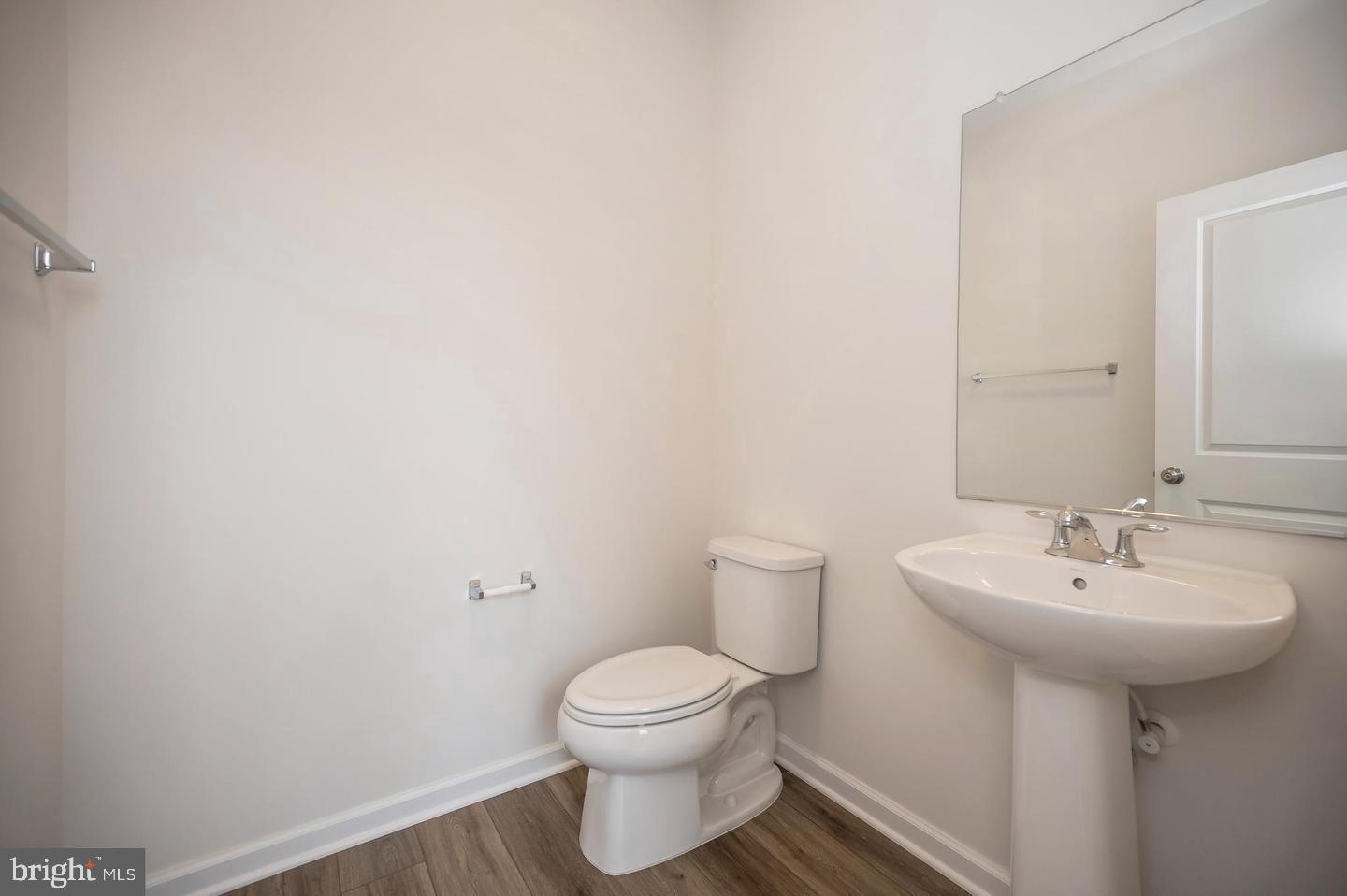 360 Coastal Avenue, Unit 102 Stafford, VA 22554 - Photo 7 of 25 a bathroom with a sink toilet and a mirror