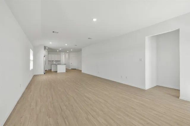 a view of kitchen and hall with wooden floor