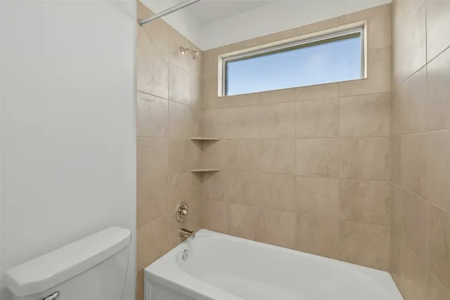 a bathroom with a white bath tub and a shower curtain