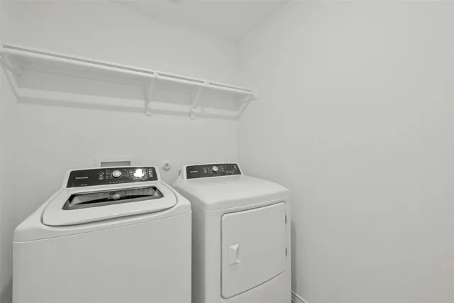 a view of storage and utility room with washer and dryer
