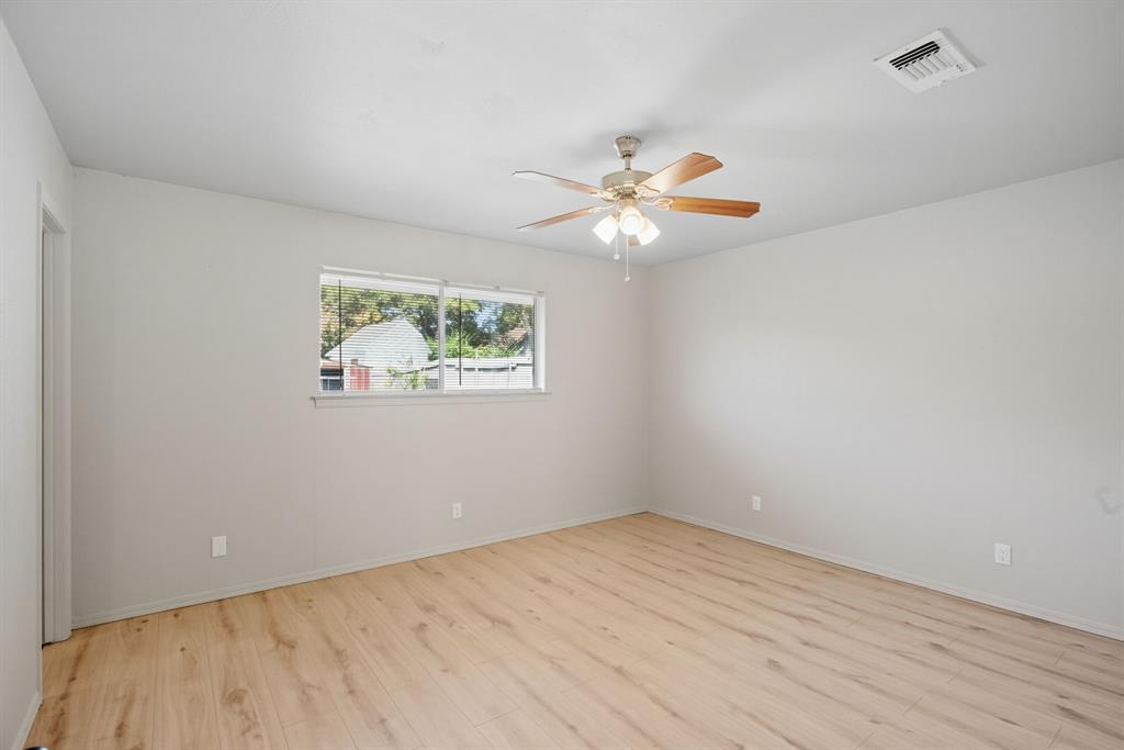 10304 Oak Creek Drive Greenville, TX 75402 - Photo 17 of 25 wooden floor in an empty room with a window