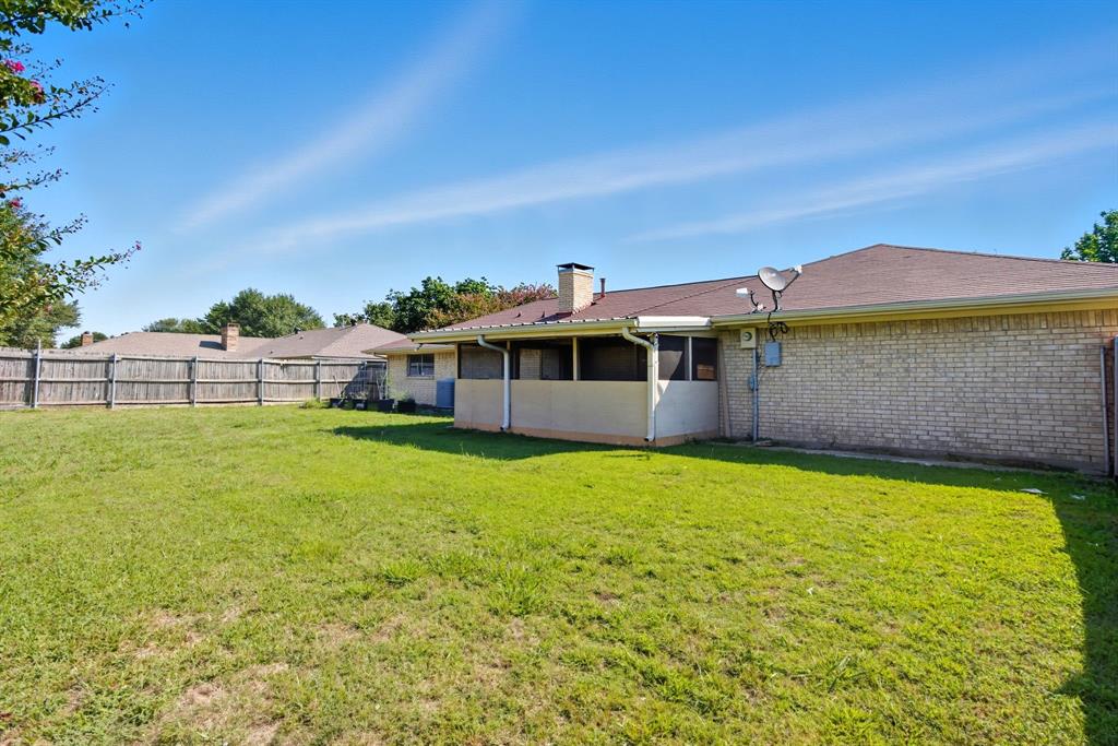 10304 Oak Creek Drive Greenville, TX 75402 - Photo 25 of 25 a front view of a house with a garden and yard