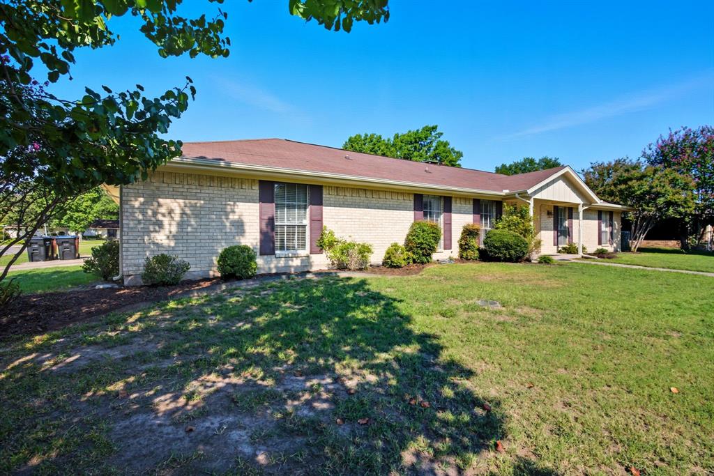 10304 Oak Creek Drive Greenville, TX 75402 - Photo 3 of 25 a front view of a house with garden