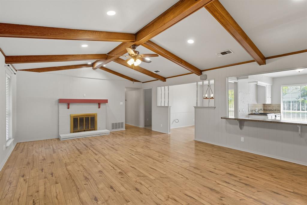 10304 Oak Creek Drive Greenville, TX 75402 - Photo 7 of 25 a view of an empty room with a fireplace and a window