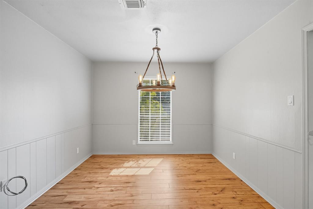 10304 Oak Creek Drive Greenville, TX 75402 - Photo 8 of 25 a view of empty room with wooden floor and fan