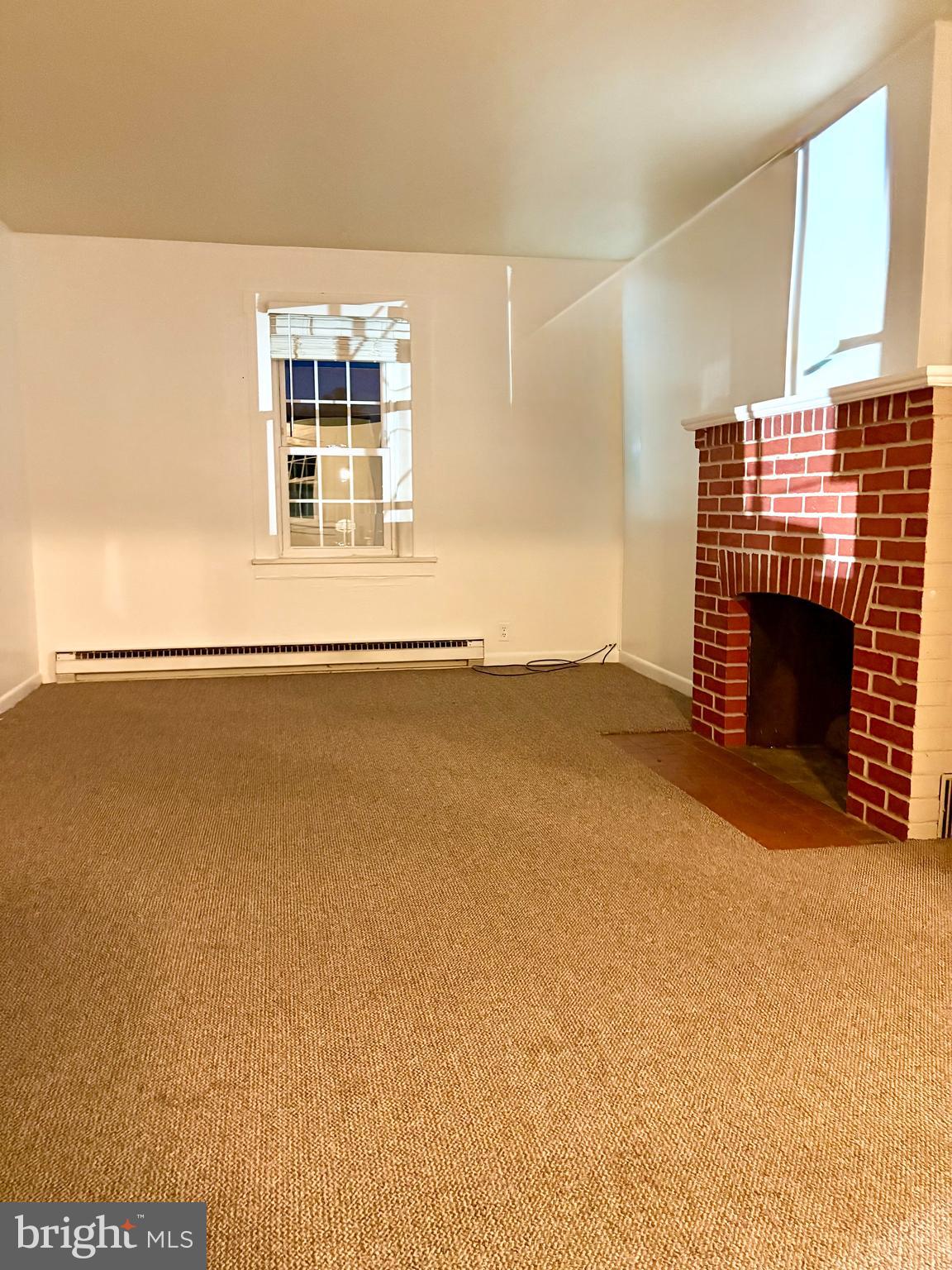 353 Rock Springs Road Conowingo, MD 21918 - Photo 6 of 16 an empty room with a fireplace