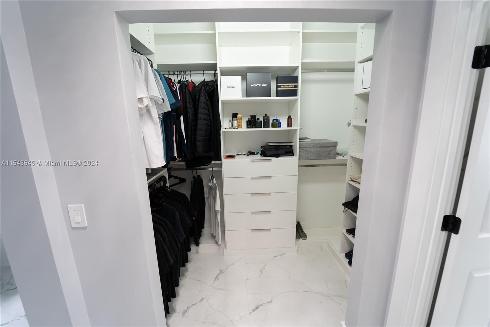 10159 Umberland Place Boca Raton, FL 33428 - Photo 12 of 25 a view of walk in closet with clothes and shoes