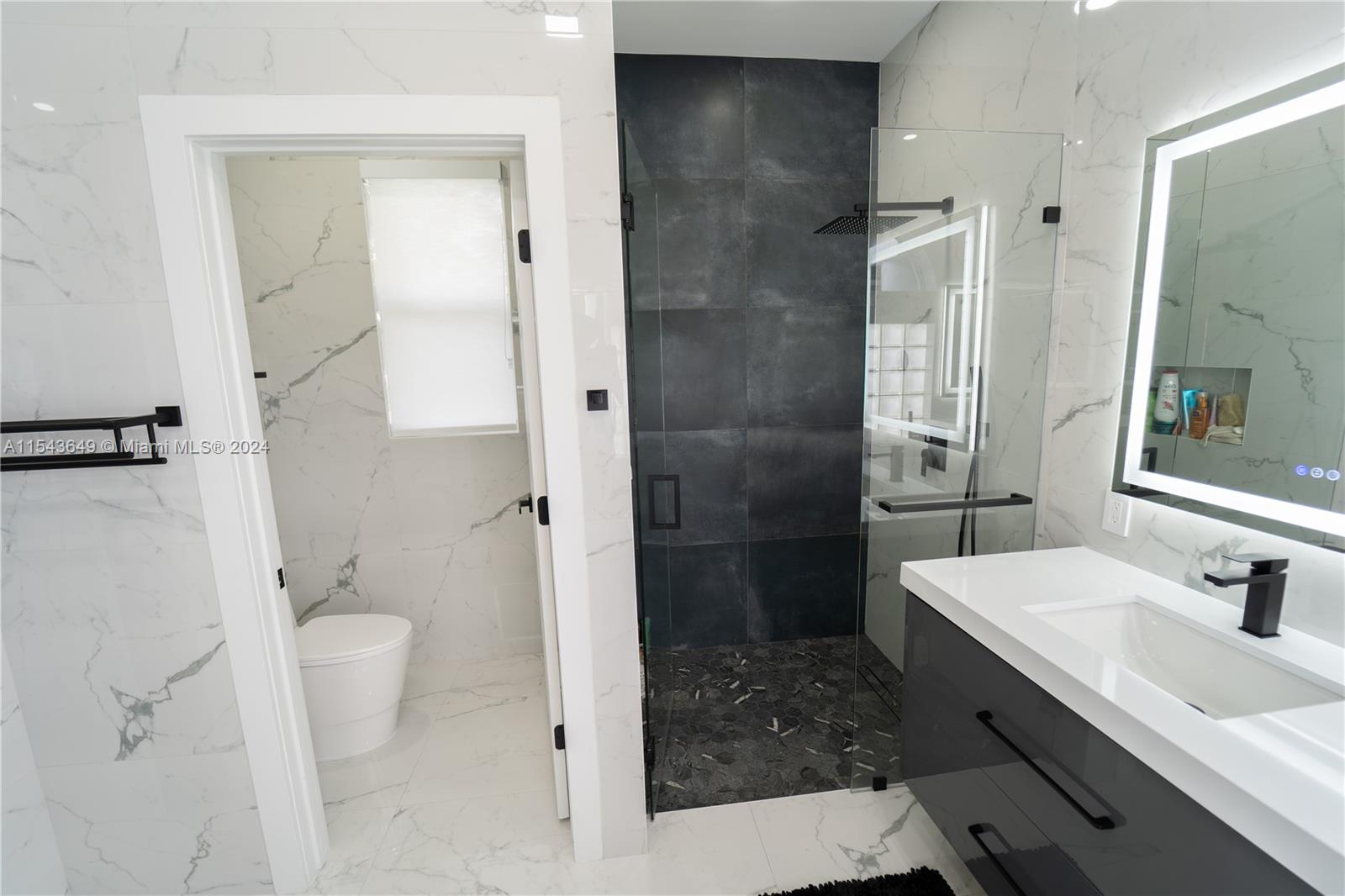 10159 Umberland Place Boca Raton, FL 33428 - Photo 18 of 25 a bathroom with a sink a toilet and shower